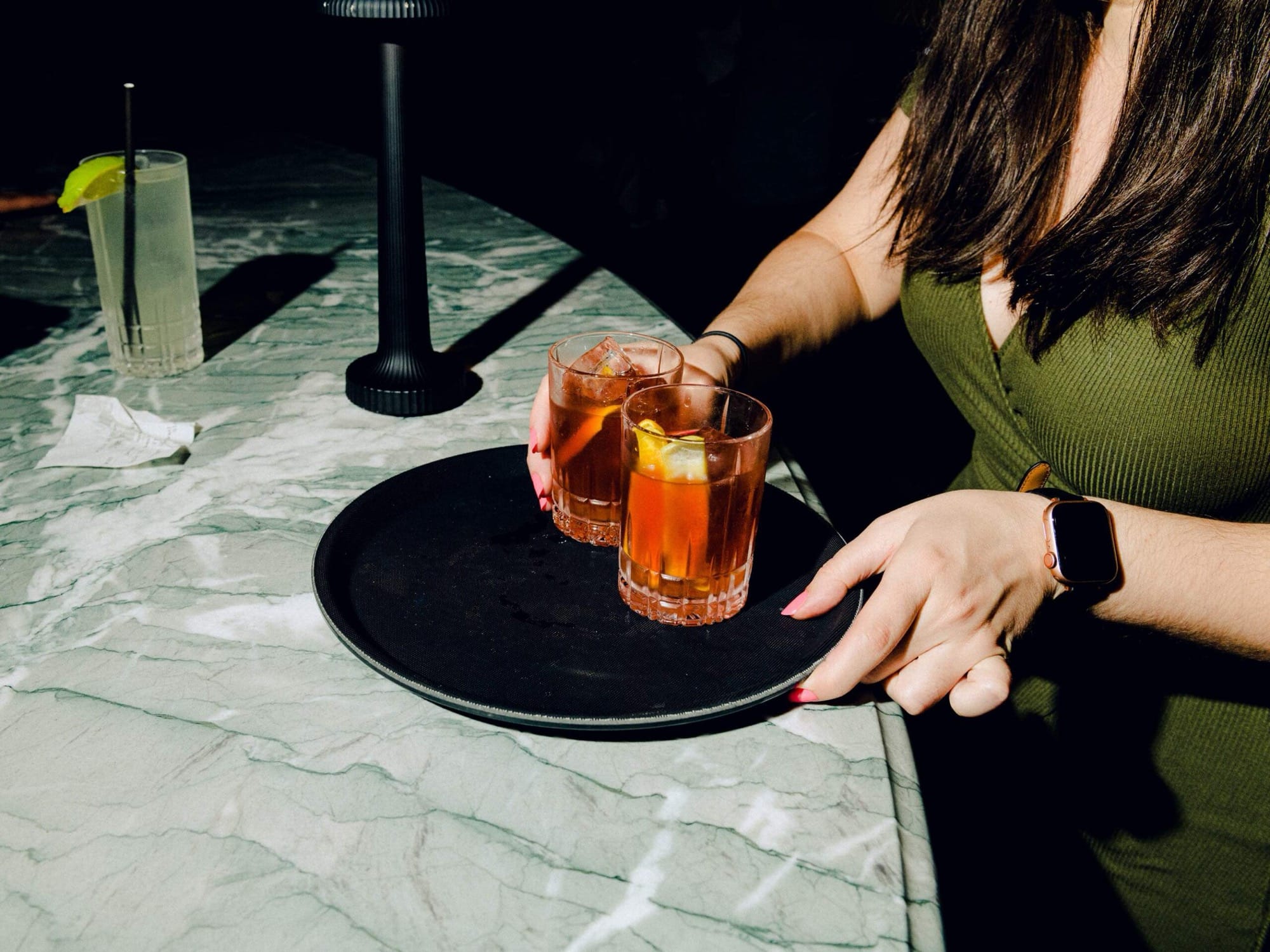 server with 2 cocktails on a bar at wyman bar (NeueHouse BradBury)